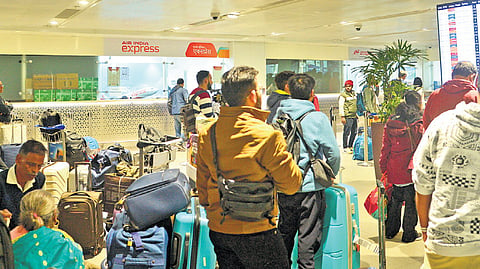 Passengers wait in a queue at T1 of the IGI Airport on Saturday. The domestic carrier has cancelled several flights.