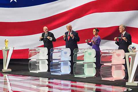 (From R-L): Canadian Prime Minister Mark Carney, Mexican President Claudia Sheinbaum, President Donald Trump and FIFA President Gianni Infantino hold up country names during the draw for the 2026 soccer World Cup at the Kennedy Center in Washington, Friday, Dec. 5, 2025.
