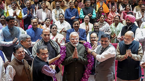 Prime Minister Narendra Modi being felicitated by MPs for the alliance' victory in Bihar Assembly elections during the NDA Parliamentary Party meeting, at Parliament premises in New Delhi, Tuesday, Dec. 9, 2025