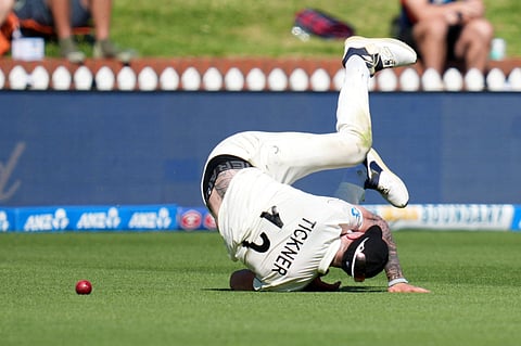 New Zealand's Blair Tickner injures himself trying to catch the ball during day one of the 2nd international Test cricket match between New Zealand and West Indies at the Basin reserve in Wellington on December 10, 2025.