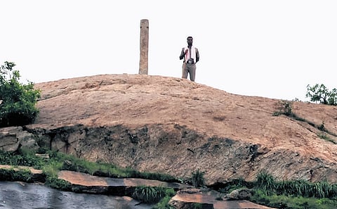 Police stand guard near the deepathoon on Thiruparankundram hill