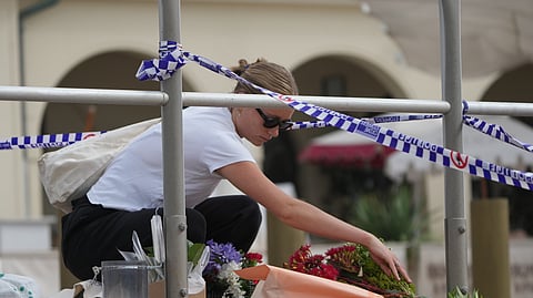 Shenna McClean lays flowers at a memorial at Sydney's Bondi Beach, Monday, Dec. 15, 2025, a day after a shooting.