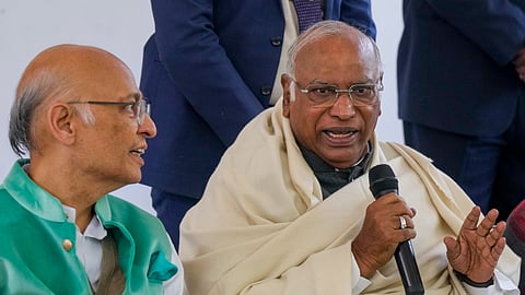 Congress President Mallikarjun Kharge, right, with party leader Abhishek Manu Singhvi addresses a press conference, in New Delhi, Wednesday, Dec. 17, 2025.