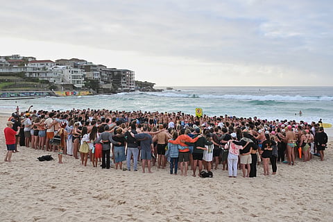 Swimmers gather for a morning vigil in Sydney, Wednesday, Dec. 17, 2025, following Sunday’s shooting at Bondi Beach.