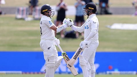 New Zealand’s Devon Conway (R) celebrates his century with Tom Latham during day one of the third international Test cricket match between New Zealand and West Indies on December 18, 2025.