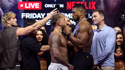 Jake Paul faces off against Anthony Joshua during the weigh-in at The Fillmore Miami Beach on December 18, 2025 in Miami Beach, Florida.