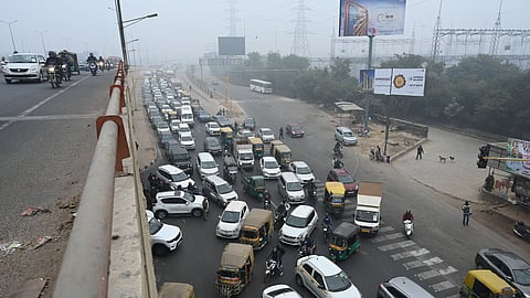 Traffic jam during Traffic police personnel stop a vehicle for document verification at the Delhi- UP Border (Ghazipur), in New Delhi, Thursday, Dec. 18, 2025.