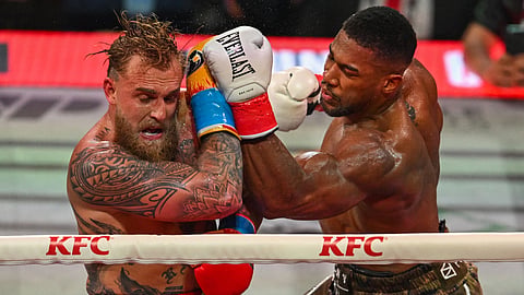US boxer and influencer Jake Paul (L) and British boxer Anthony Joshua fight in a non-title heavyweight bout at the Kaseya Center in Miami, Florida on December 19, 2025.