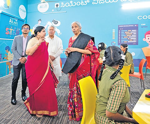 Finance Minister Nirmala Sitharaman interacts with students after inaugurating an AI-based education tool at a school in Hosapete on Saturday