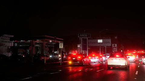 Cars wait at an intersection with no working traffic lights from power outages, in San Francisco, Saturday, Dec. 20, 2025.