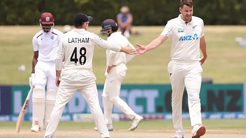 New Zealand’s Jacob Duffy (R) and Tom Latham (L) react during day five of the 3rd international Test cricket match between New Zealand and West Indies on December 22, 2025.