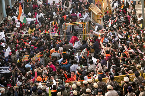 Vishwa Hindu Parishad (VHP) and Bajrang Dal members overturn barricades during a protest outside the Bangladesh High Commission over attacks on Hindus in the neighbouring country, in New Delhi, Tuesday, Dec. 23, 2025.