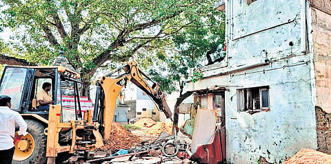 Officials pull down the houses built on encroached mutt land on Tuesday