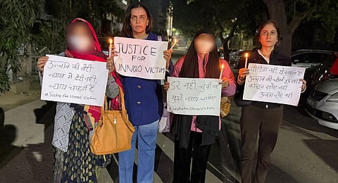 Activist Yogita Bhayana along with the family of Unnao rape survivor during a protest agaisnt the Delhi HC order.