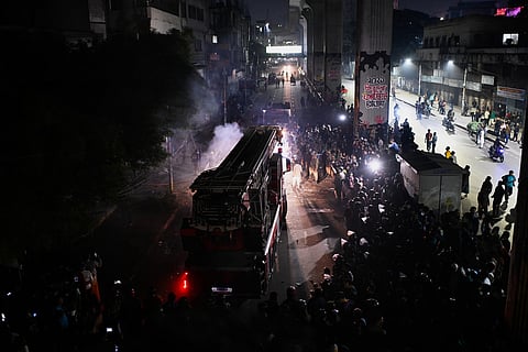 A fire engine arrives at the premises of The Daily Star newspaper after angry protesters set it on fire after news reached the country from Singapore of the death of a prominent activist Sharif Osman Hadi, in Dhaka, Bangladesh, Friday, Dec. 19, 2025.