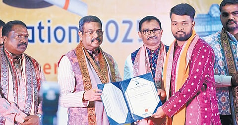 Union Minister Pradhan presenting degree certificate to a student