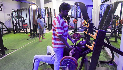 Youths work out in a Gym in Tiruchy on Monday.
