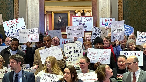 People gather for a news conference at the state capitol in St. Paul, Minn., on Wednesday, Dec. 31, 2025.
