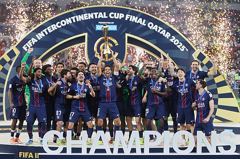 PSG's Marquinhos lifts the trophy after winning the FIFA Intercontinental Cup final soccer match between Flamengo and Paris Saint-Germain in Doha, Qatar, Wednesday, Dec. 17, 2025.