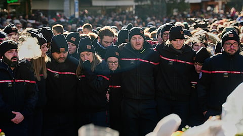 Firefighters cry, standing outside the Chapelle St-Christophe, during a memorial mass in Crans-Montana, Swiss Alps, Switzerland, Sunday, Jan. 4, 2026, after a devastating fire in Le Constellation bar left dead and injured during the New Year's celebrations.
