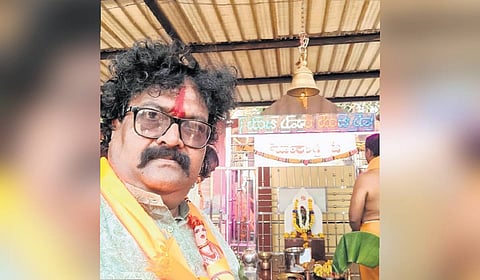 Lalsab Budihal in front of the temple at the bus depot in Dharwad.
