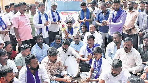 Members of Dalit organisations stage a protest in front of KIMS Hubbali on Sunday.