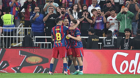 Barcelona's Fermin Lopez (R) celebrates with teammates after scoring his team's second goal during the Spanish Supercup semi-final football match between FC Barcelona and Athletic Bilbao in Jeddah on January 7, 2026.