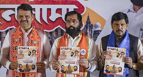 Maharashtra Chief Minister Devendra Fadnavis with state Deputy Chief Minister Ekanth Shinde and others during the launch of Mahayuti's manifesto for BMC elections, in Mumbai, Sunday, Jan. 11, 2026.