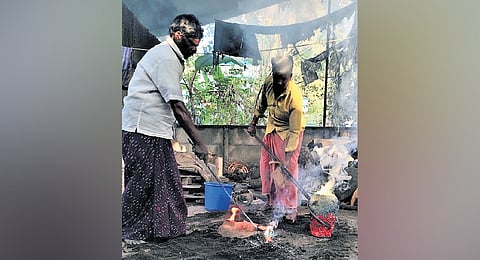 Craftsmen moulding a brass utensil at Mannar