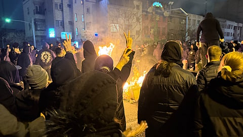 Iranians attend an anti-government protest in Tehran, Iran, Friday, Jan. 9, 2026.