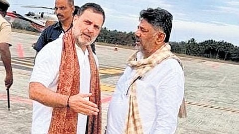 Rahul Gandhi in conversation with DK Shivakumar at the tarmac of Mysuru airport on Tuesday.