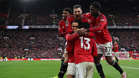 Manchester United's Danish defender #13 Patrick Dorgu celebrates with teammates after scoring their second goal during the English Premier League football match between Manchester United and Manchester City at Old Trafford in Manchester, north west England, on January 17, 2026.