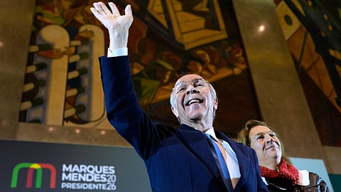 Presidential candidate Luis Marques Mendes, from the center-right Social Democratic Party, with his wife Rosa Sofia Salazar, gestures to supporters while campaigning for Sunday's presidential election, in Lisbon, Portugal, Friday, Jan. 16, 2026.