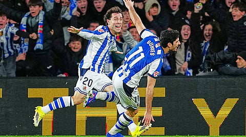 Real Sociedad's Goncalo Guedes, right, celebrates with Real Sociedad's Alvaro Odriozola after scoring his side's second goal during the Spanish La Liga soccer match between Real Sociedad and Barcelona on Jan. 18, 2026.