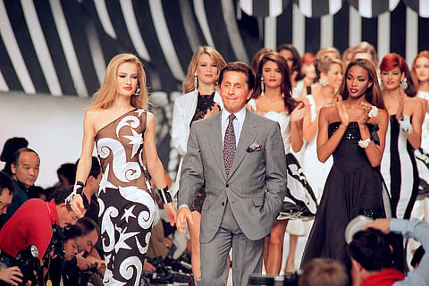 Italian fashion designer Valentino Garavani walks the catwalk with his models after a fashion show.