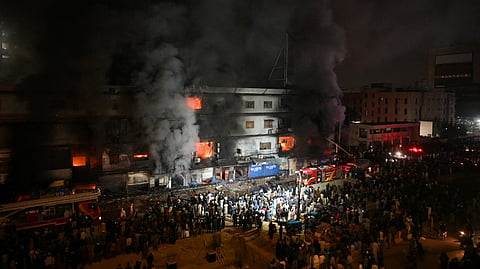 Firefighters douse a fire that broke out at a shopping mall in Karachi on January 18, 2026.