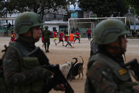 Soldiers receive instructions on a soccer field before patrolling the city during the country's state of emergency, following an escalation of gang-related violence, on the outskirts of Guatemala City, Tuesday, Jan. 20, 2026.
