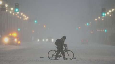 A person pushed a bicycle during a winter storm in Philadelphia, Sunday, Jan. 25, 2026.