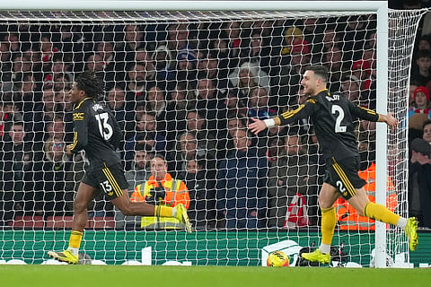 Manchester United's Patrick Dorgu, left, celebrates scoring his side's second goal during the English Premier League soccer match between Arsenal and Manchester United in London, Sunday, Jan. 25, 2026. (AP Photo/Kirsty Wigglesworth)