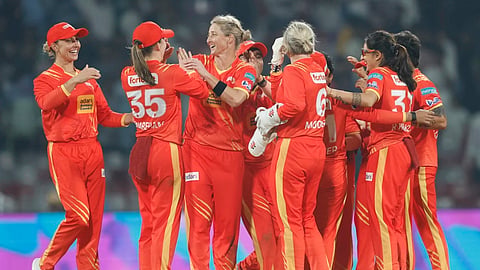 Sophie Devine (3rd from left) celebrates a wicket with her teammates
