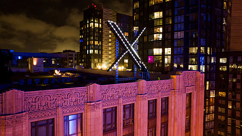 FILE - Workers install lighting on an "X" sign atop the company headquarters, formerly known as Twitter, in downtown San Francisco, July 28, 2023.