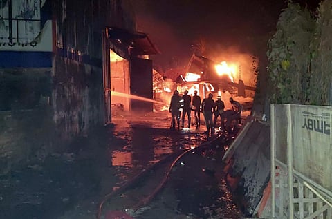 The blaze erupted around 3 am on Monday, and it was still raging after 24 hours, with pockets of fire continuing to smoulder inside the gutted structures, officials said.