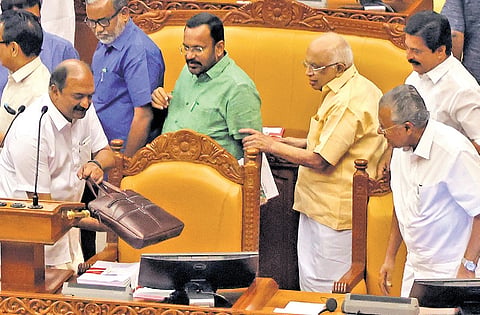 Chief Minister Pinarayi Vijayan and other ministers look on as Finance Minister K N Balagopal, carefully places the bag containing the budget speech on the desk at the Legislative Assembly Hall on Thursday