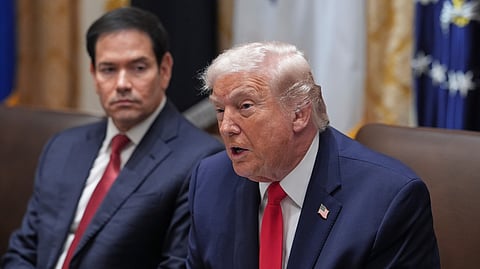 President Donald Trump speaks as Secretary of State Marco Rubio listens during a meeting at the White House.