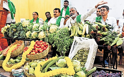 Members of the Karnataka State Farmers’ Association stage a demonstration in Bengaluru on Friday against the acquisition of agricultural land by the Karnataka Industrial Areas Development Board for a proposed railway line between Bettahalasur and Rajanukunte