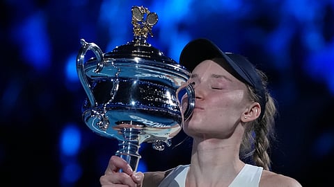 Elena Rybakina of Kazakhstan kisses the Daphne Akhurst Memorial Cup after defeating Aryna Sabalenka of Belarus to win the women's singles final at the Australian Open tennis championship in Melbourne, Australia, Saturday, Jan. 31, 2026.