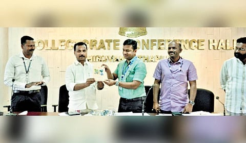 MLA V K Prasanth releasing the District Handbook 2025 by handing it over to Additional District Magistrate Vineeth T K