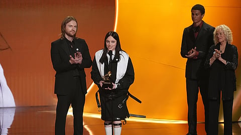 Finneas, left, and Billie Eilish accept the award for song of the year for "Wildflower" during the 68th annual Grammy Awards on Sunday, Feb. 1, 2026, in Los Angeles. Carole King looks on from right.