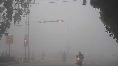 Commuters ply on a road amid dense fog on a winter morning, in New Delhi, Tuesday, Feb. 3, 2026