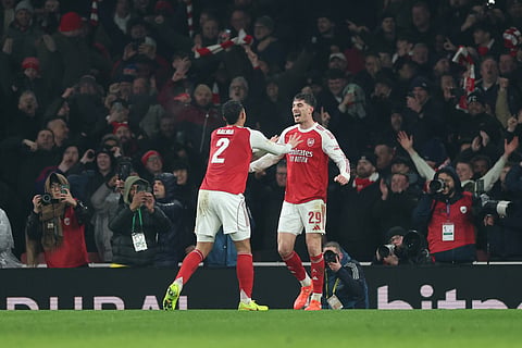 Arsenal's Kai Havertz, right, celebrates with Arsenal's William Saliba after scoring the opening goal during the English League Cup semifinal second leg soccer match between Arsenal and Chelsea in London, Tuesday, Feb. 3, 2026.